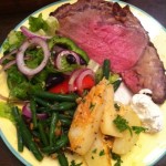 Prime rib roast, roasted potatoes, green beans, Greek salad, and creamed horseradish