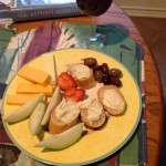 Bread, cheeses, fruit, some olives, wine & required reading